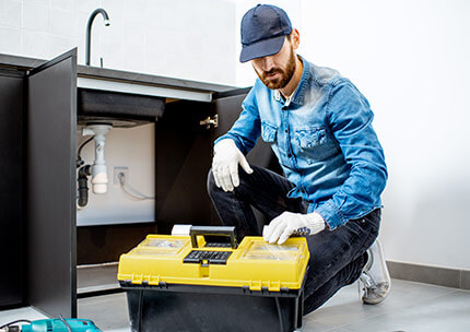 man-repairing-kitchen-furniture-B3TW26Q.jpg